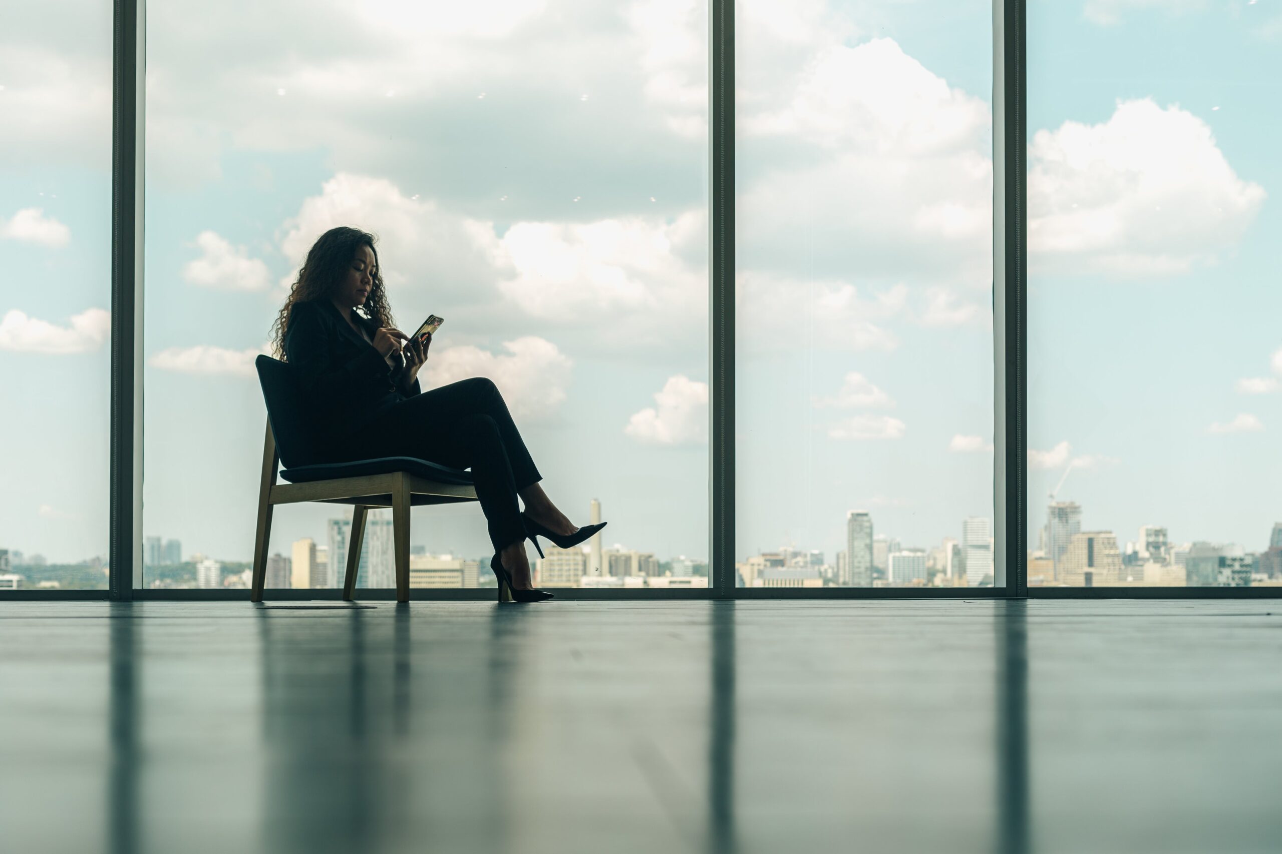 woman-sitting-on-phone-in-modern-office-chair